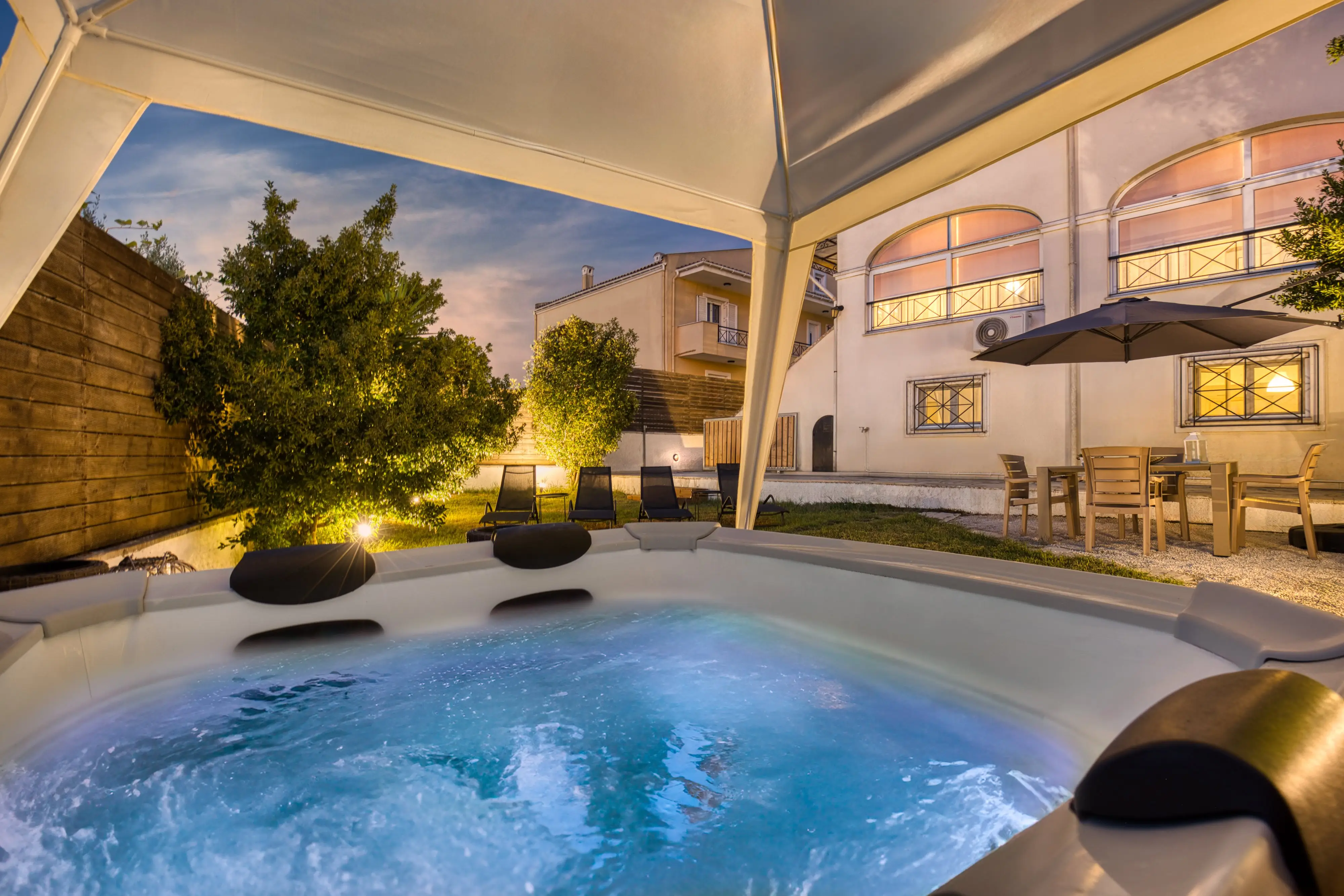 Outdoor jacuzzi and illuminated garden at Mi Casa Corfu